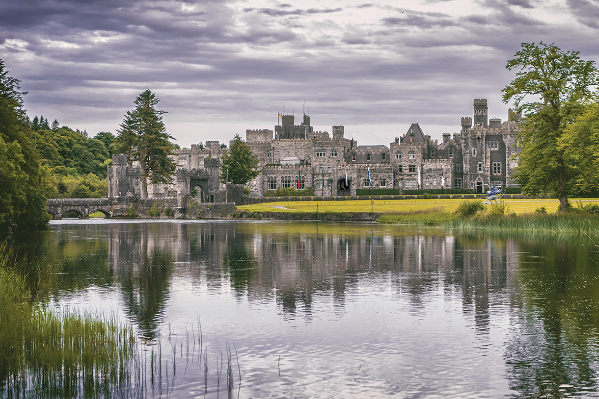 Exterior of Ashford Castle with lake in front